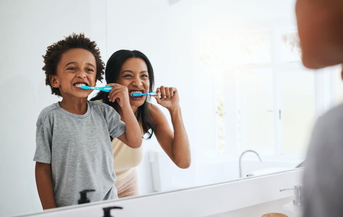 A mother and her son sharing a moment of dental hygiene and bonding at home